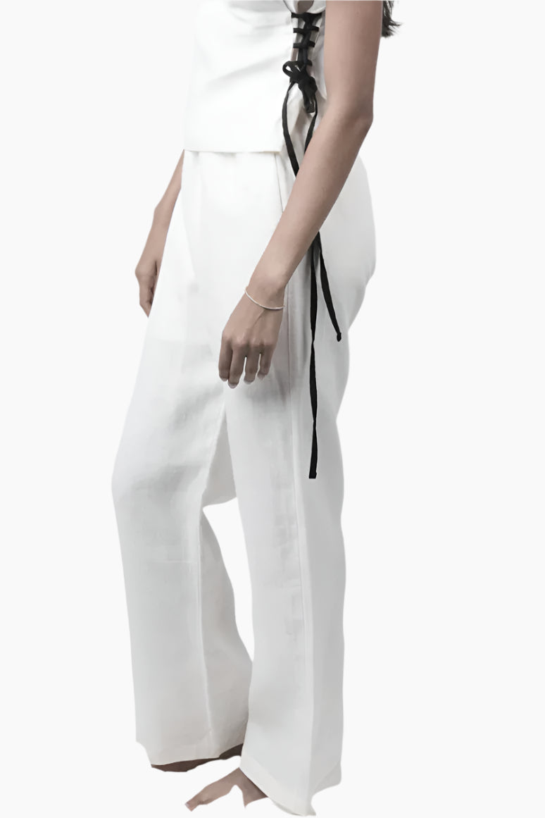 Relaxed yet redefined, these wide-leg pants are crafted from air pure Linen for effortless movement. Featuring an elastic waist for a comfortable fit, discreet side pockets, and a soft inner short lining for added coverage, perfectly paired with a Sleeveless lace up to for an adjusted waist and polished look.
