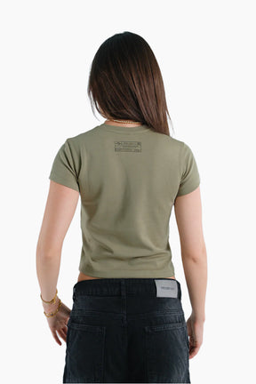 Person wearing a green t-shirt with text on the back