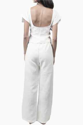 Relaxed yet redefined, these wide-leg pants are crafted from air pure Linen for effortless movement. Featuring an elastic waist for a comfortable fit, discreet side pockets, and a soft inner short lining for added coverage, perfectly paired with a Sleeveless lace up to for an adjusted waist and polished look.