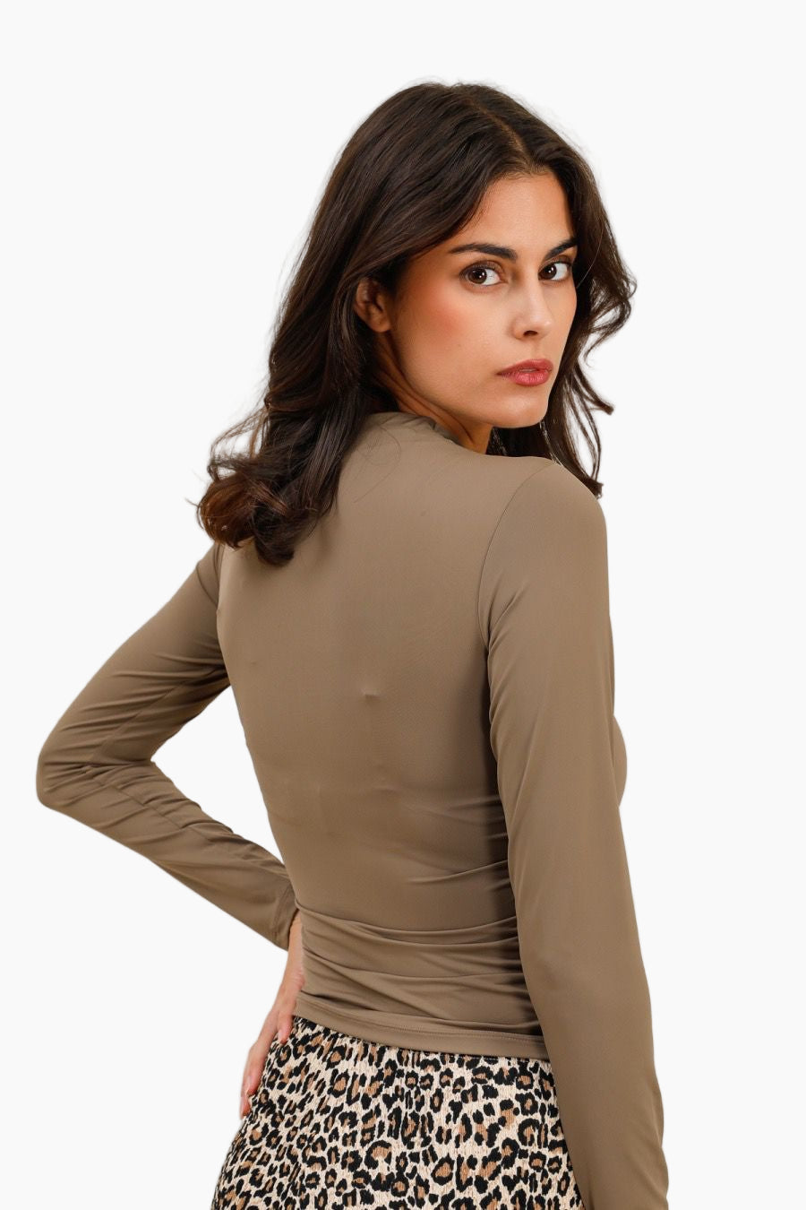 Woman wearing a brown long-sleeve top with a leopard print skirt 
