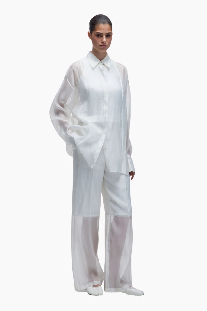 Person wearing a white outfit on a white background