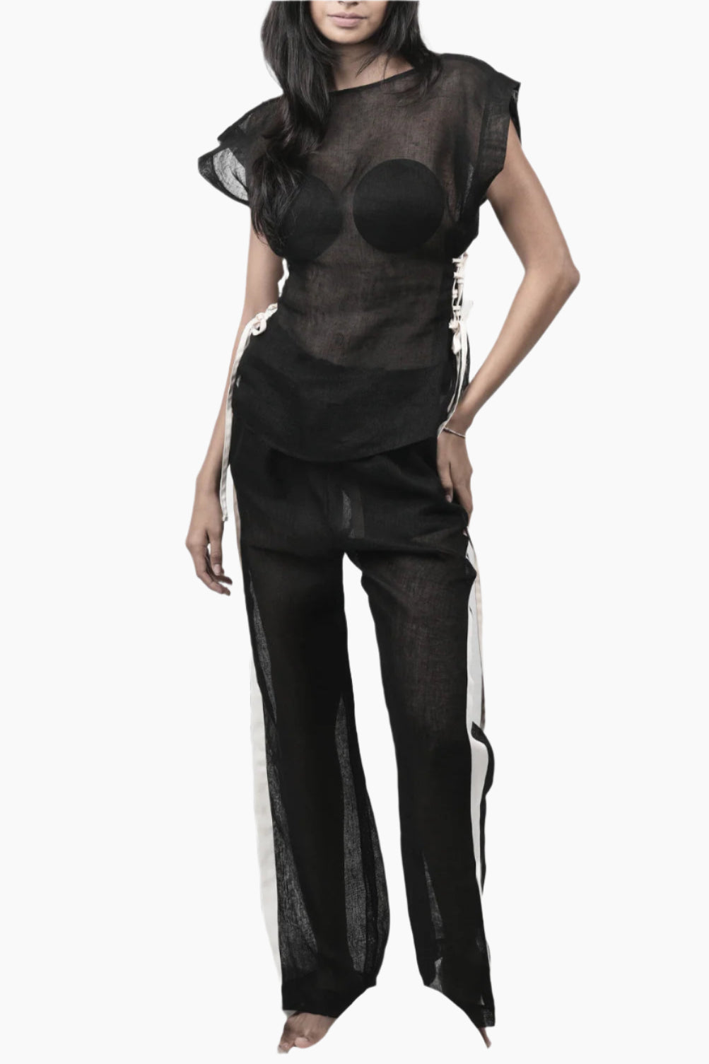 Person wearing a black sheer outfit 