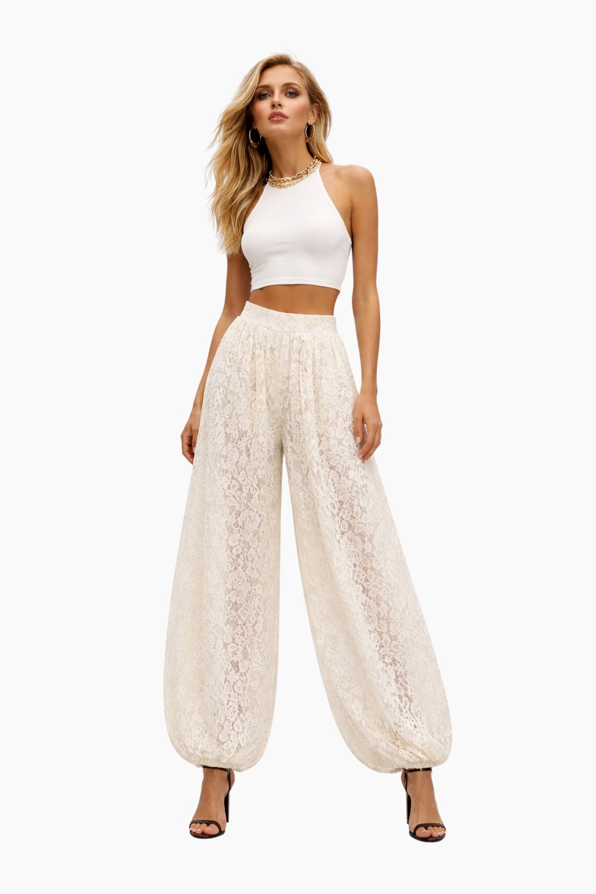 Woman wearing a white lace pants and top set on a white background