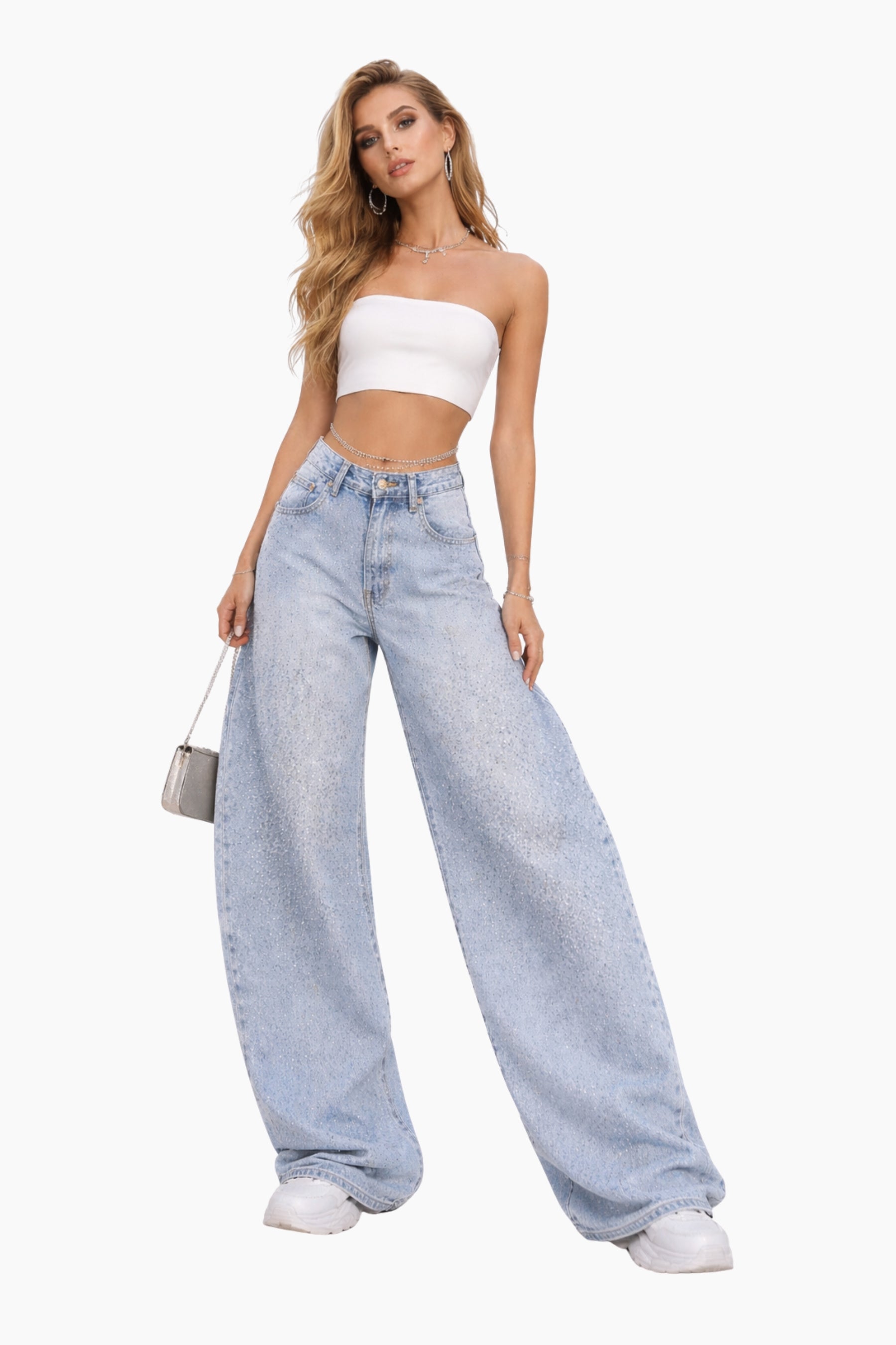 Woman wearing a white strapless top and light blue jeans on a white background