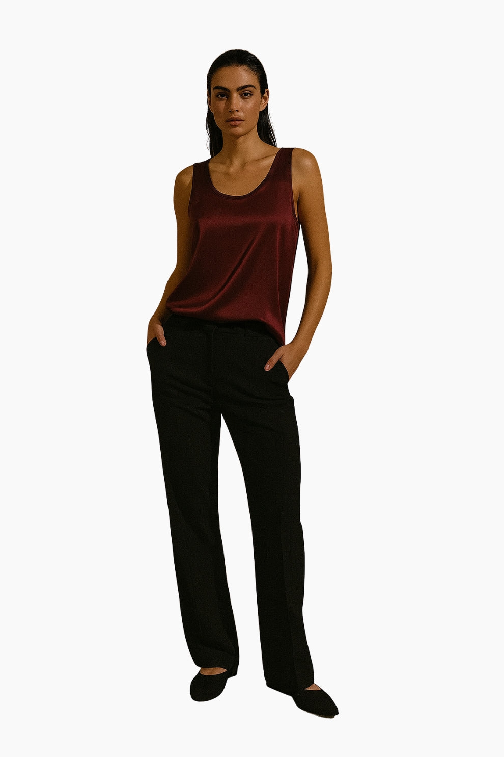 Woman wearing a burgundy tank top and black pants 