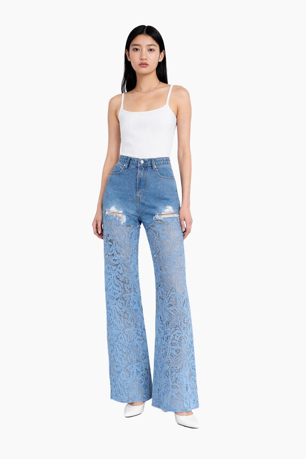 Woman wearing a white top and blue distressed jeans on a white background