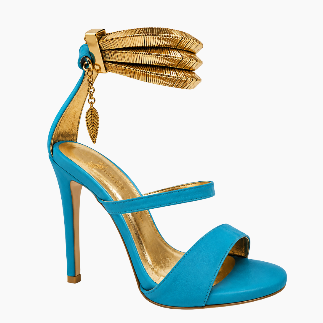 A single turquoise blue high-heeled sandal with a gold metallic ankle strap, gold insole, and a gold leaf charm, shown against a plain white background.