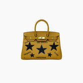 Yellow handbag with star designs and text on a white background