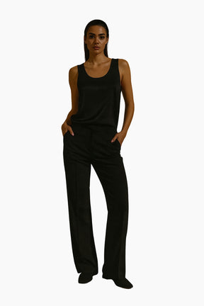 Person wearing a black tank top and black pants 