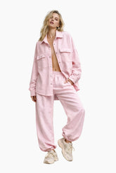 Woman wearing a pink outfit on a white background