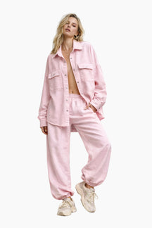 Woman wearing a pink outfit on a white background