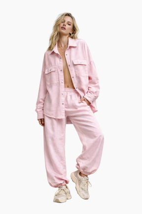 Woman wearing a pink outfit on a white background
