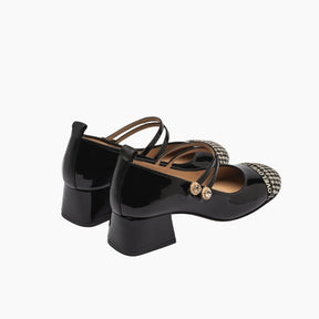 Black patent leather shoes with a strap and decorative element
