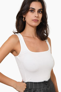 Woman wearing a white tank top 