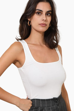 Woman wearing a white tank top 
