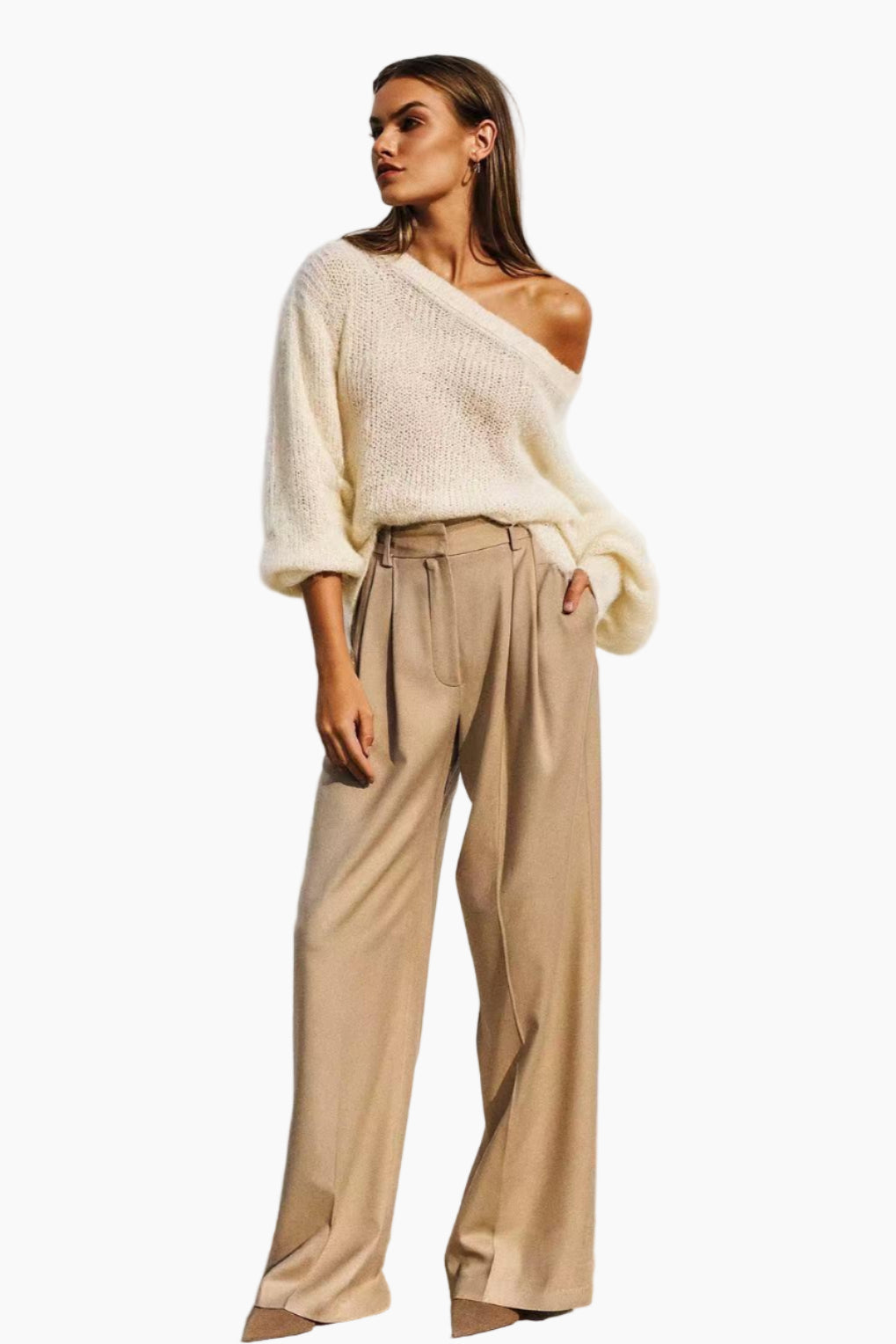 Woman wearing a white sweater and beige pants
