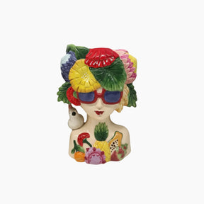 Colorful figurine with fruit hat and sunglasses on a white background
