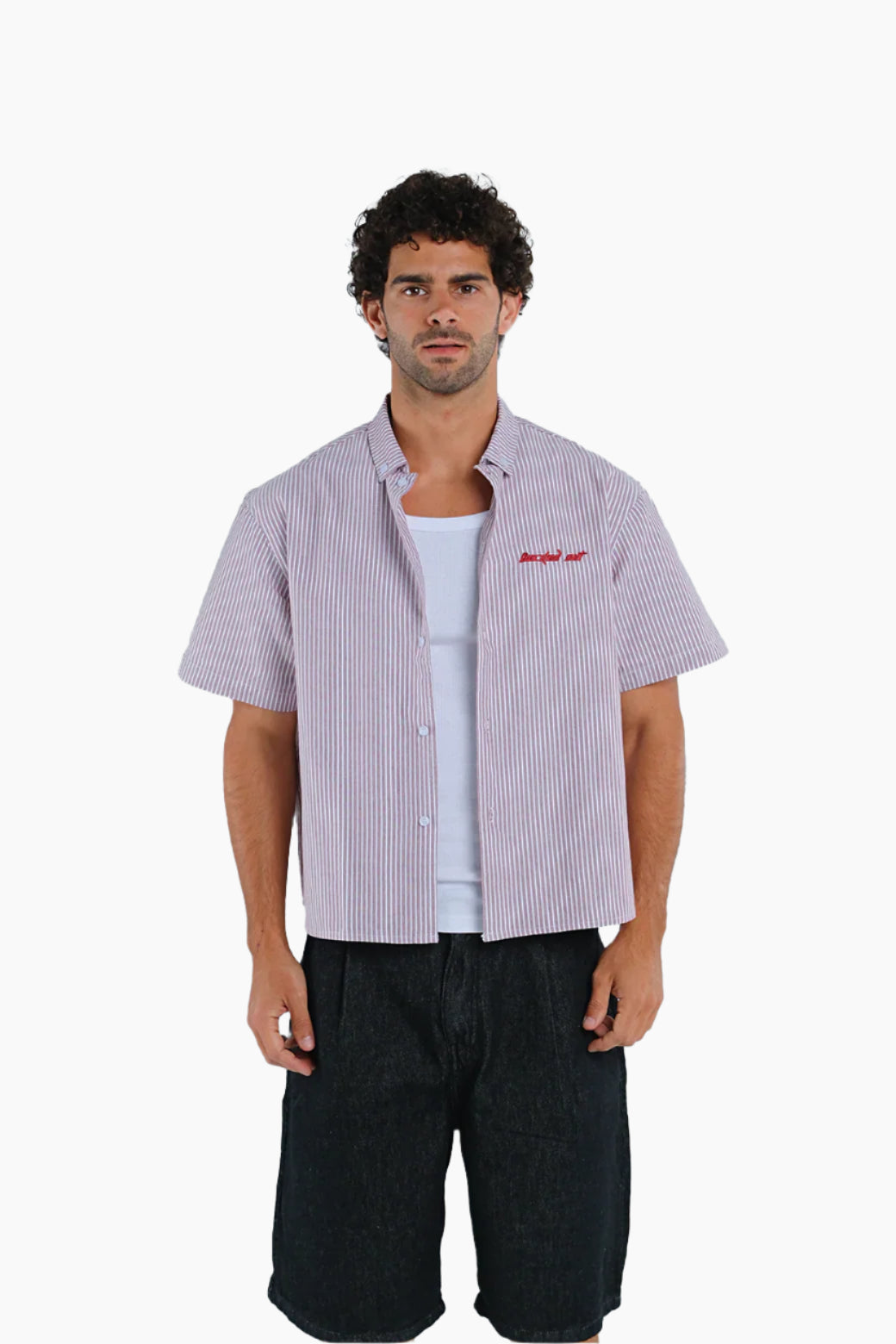 Man wearing a checkered shirt over a white t-shirt with text