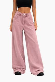 Person wearing pink wide-leg jeans on a white background