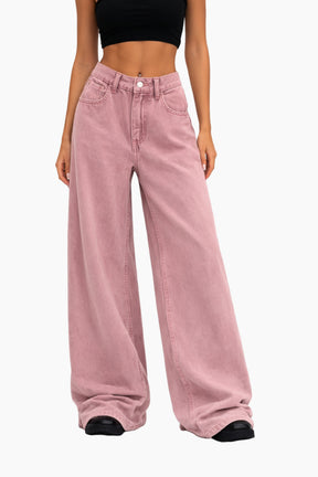 Person wearing pink wide-leg jeans on a white background
