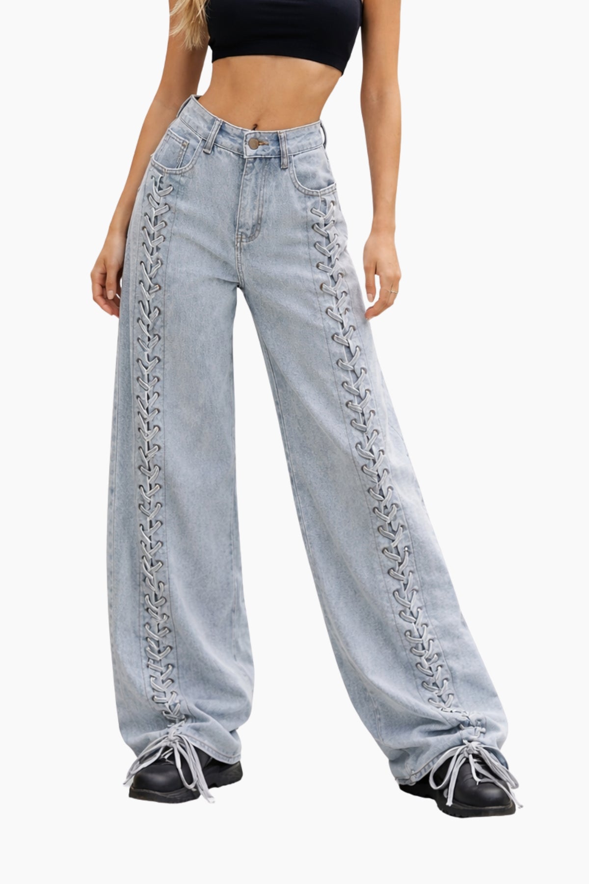Light blue jeans with decorative stitching worn by a person on a white background