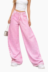 Person wearing pink wide-leg pants and a white top on a white background