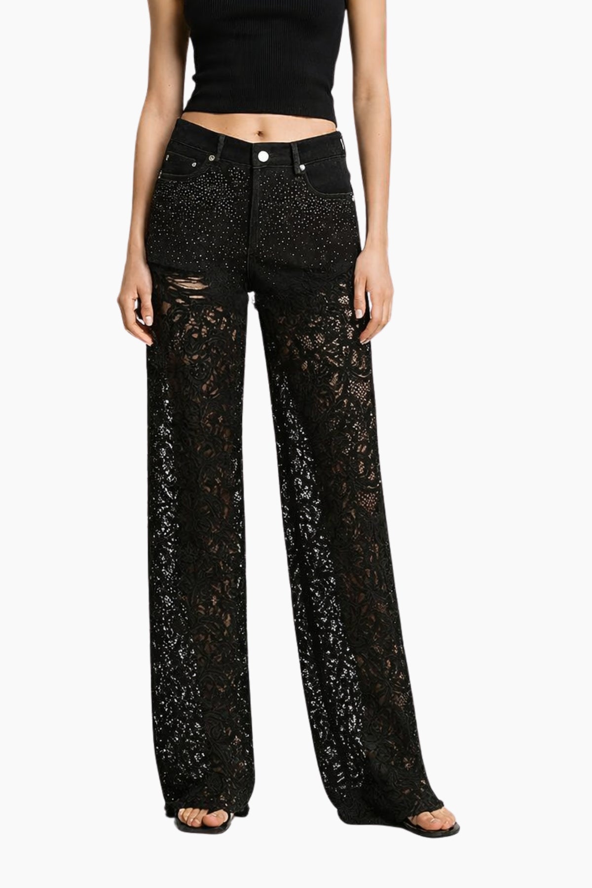 Black lace pants worn by a model on a white background