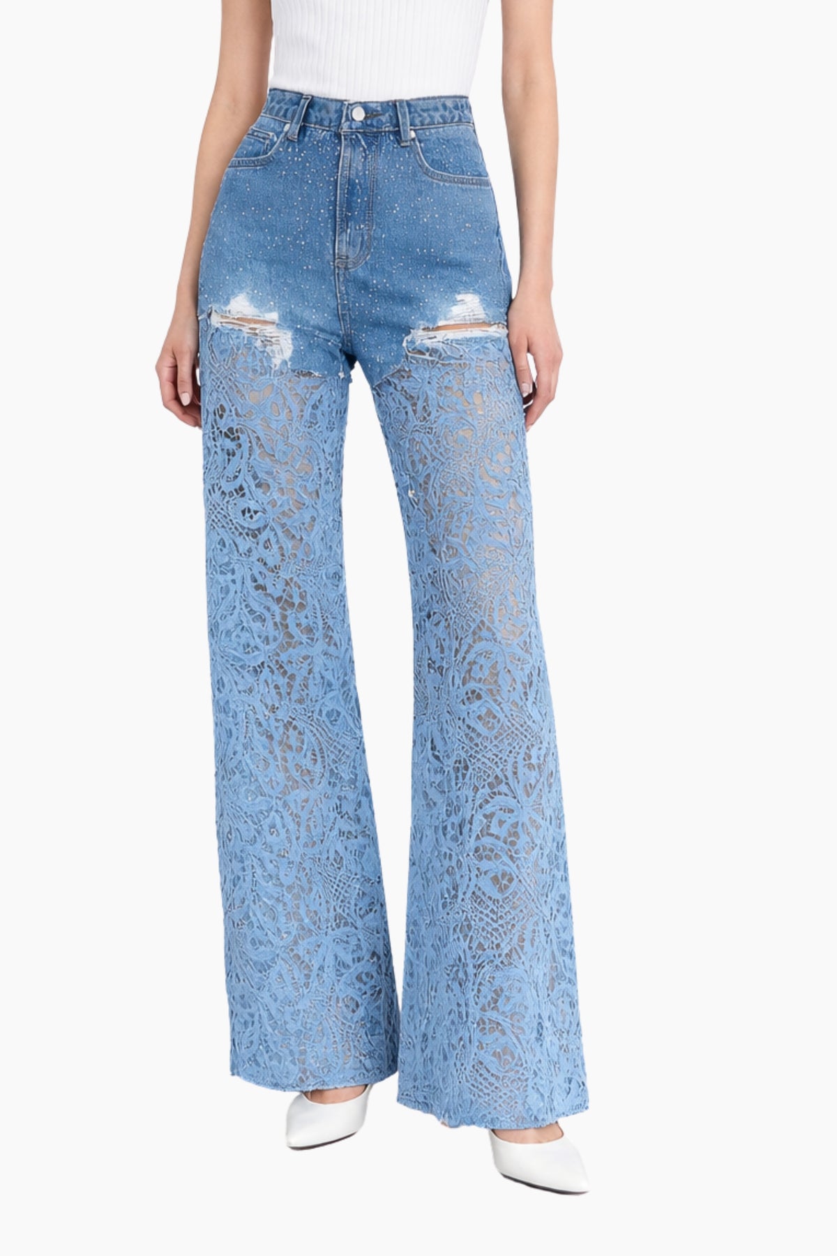 Light blue jeans with distressed details worn by a person on a white background