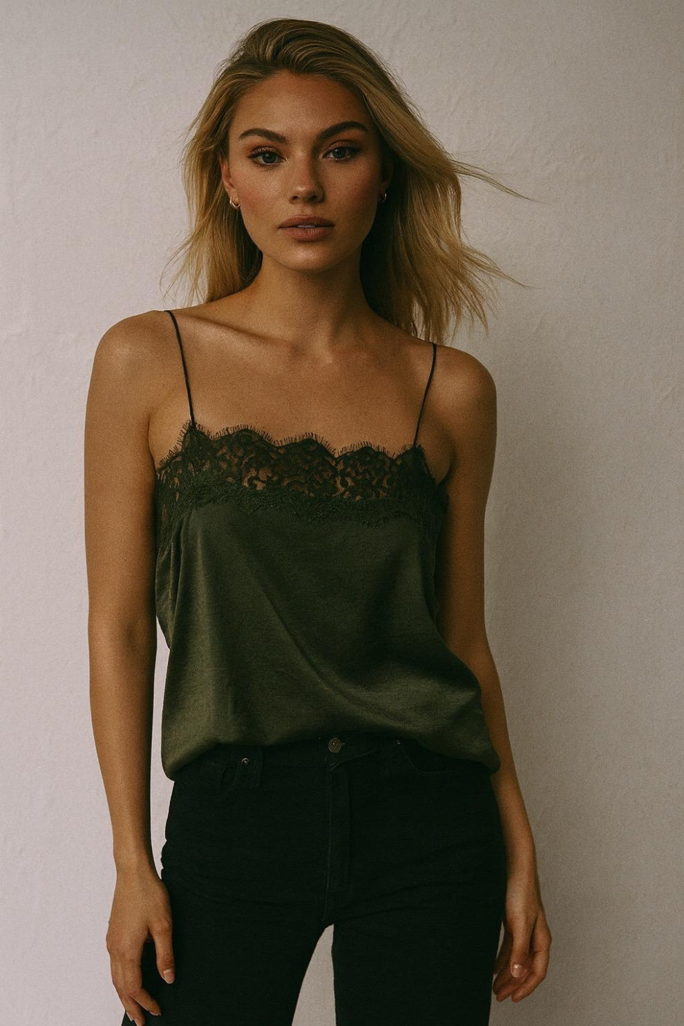 Woman wearing a green lace-trimmed top