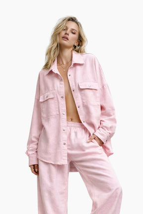 Woman wearing a pink outfit on a white background