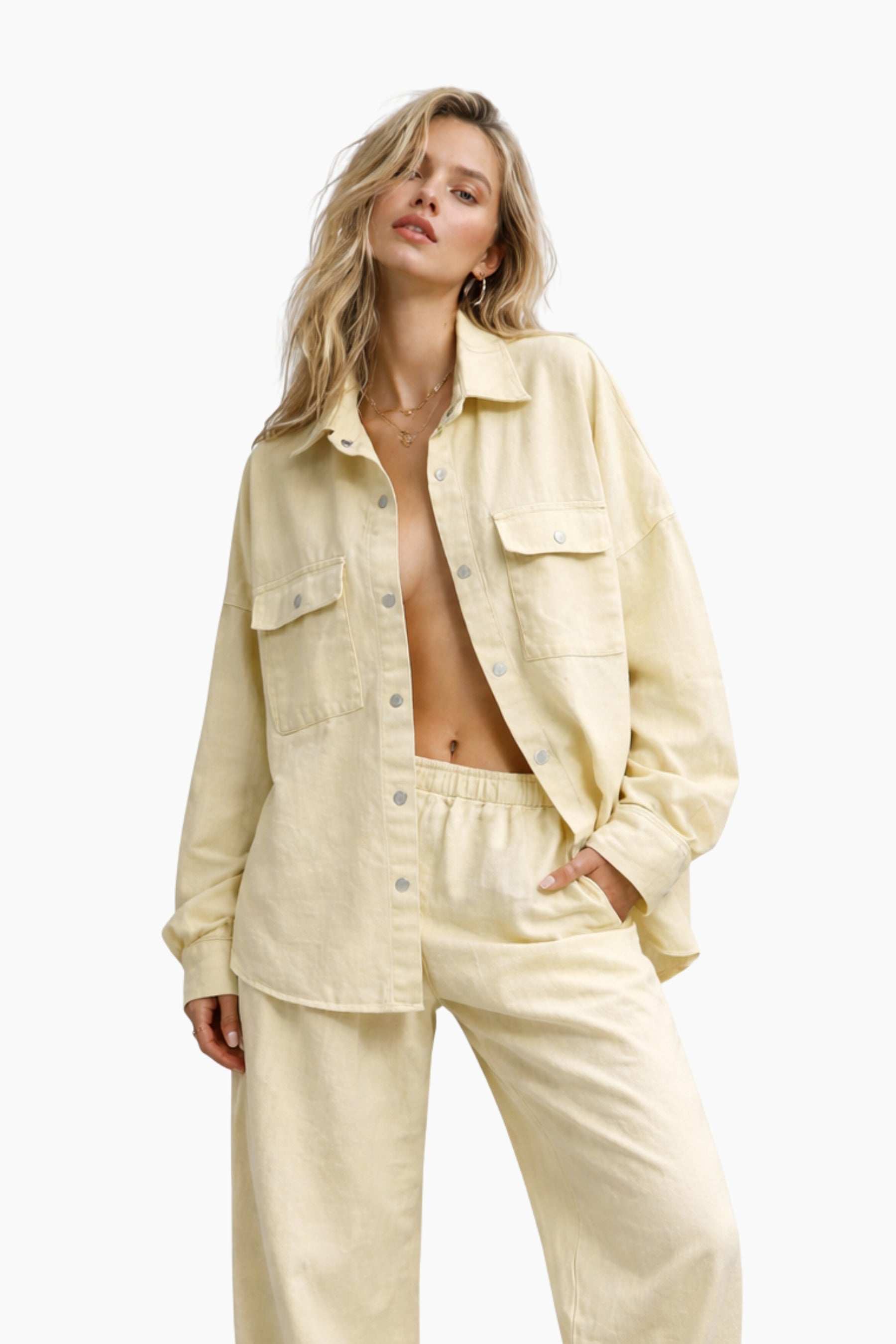 Woman wearing a light yellow denim jacket and pants on a white background