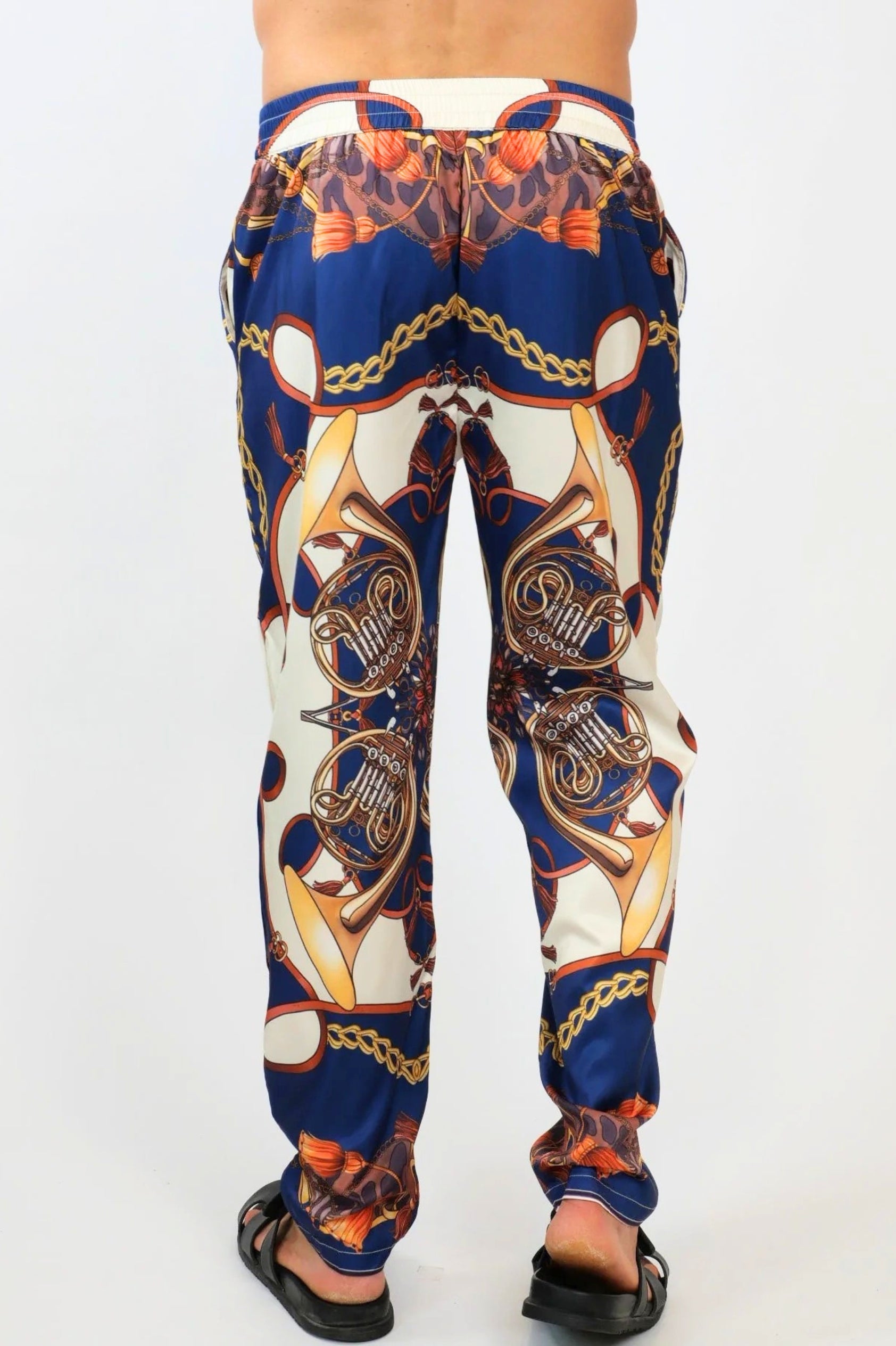 Colorful patterned pants worn by a person on a white background