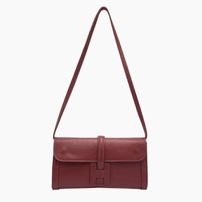 Red leather handbag with a strap on 