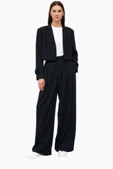 Woman wearing a black suit with a white shirt 