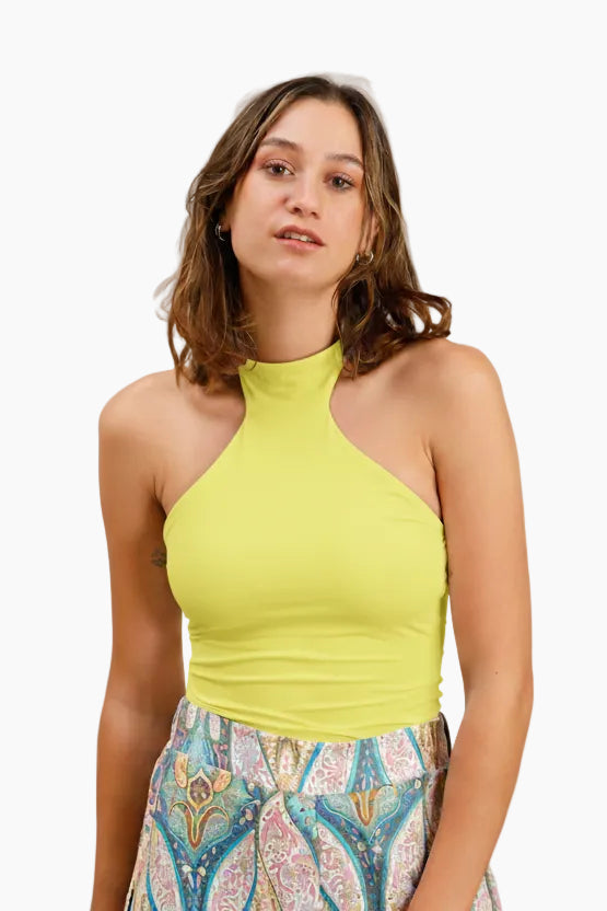 Woman wearing a white halter top and colorful patterned skirt 