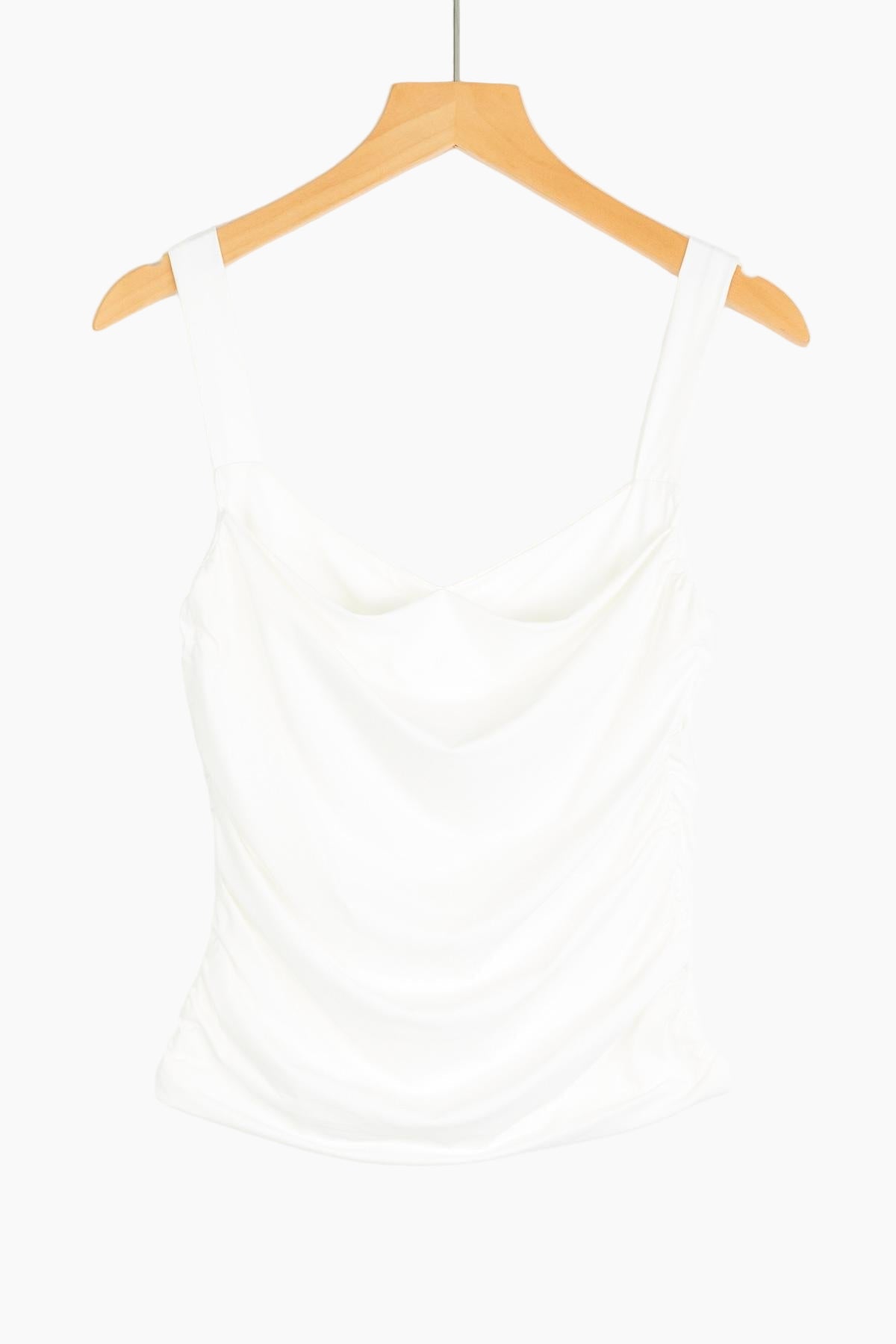 White tank top on a wooden hanger 