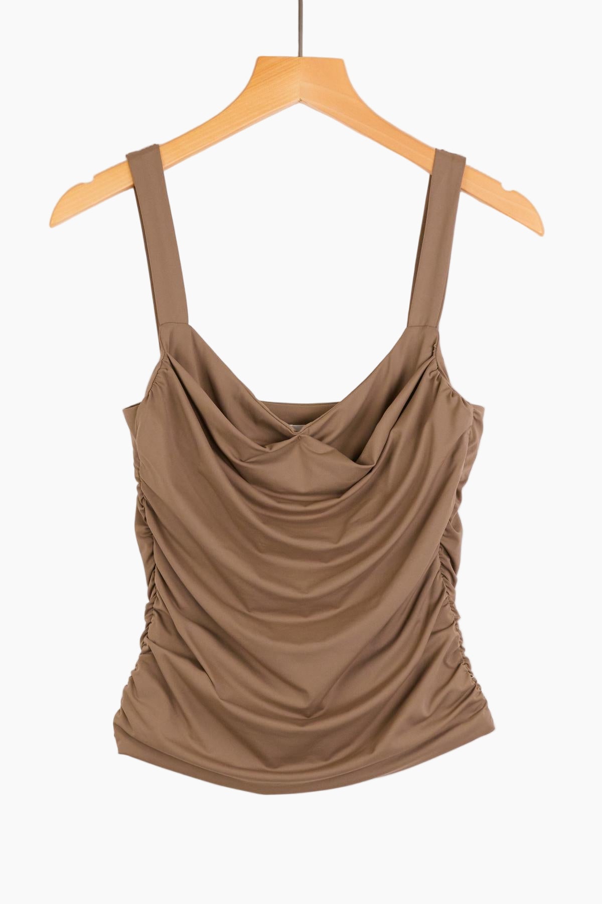 Brown sleeveless top on a wooden hanger 