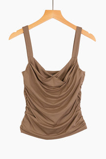 Brown sleeveless top on a wooden hanger 