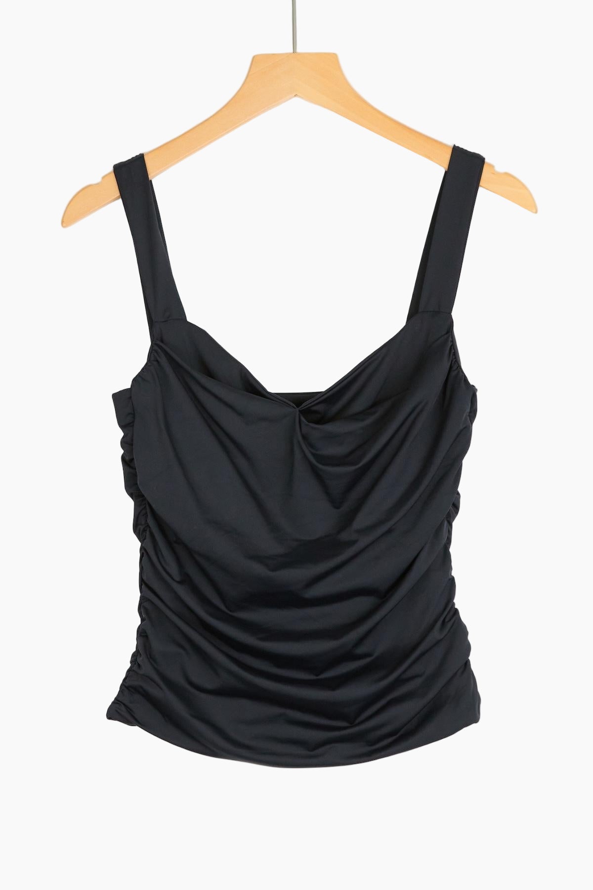 Black draped tank top on a wooden hanger