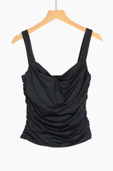 Black draped tank top on a wooden hanger