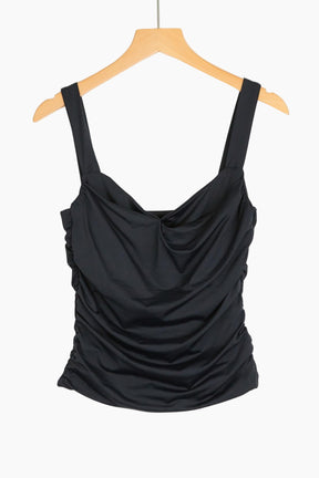 Black draped tank top on a wooden hanger