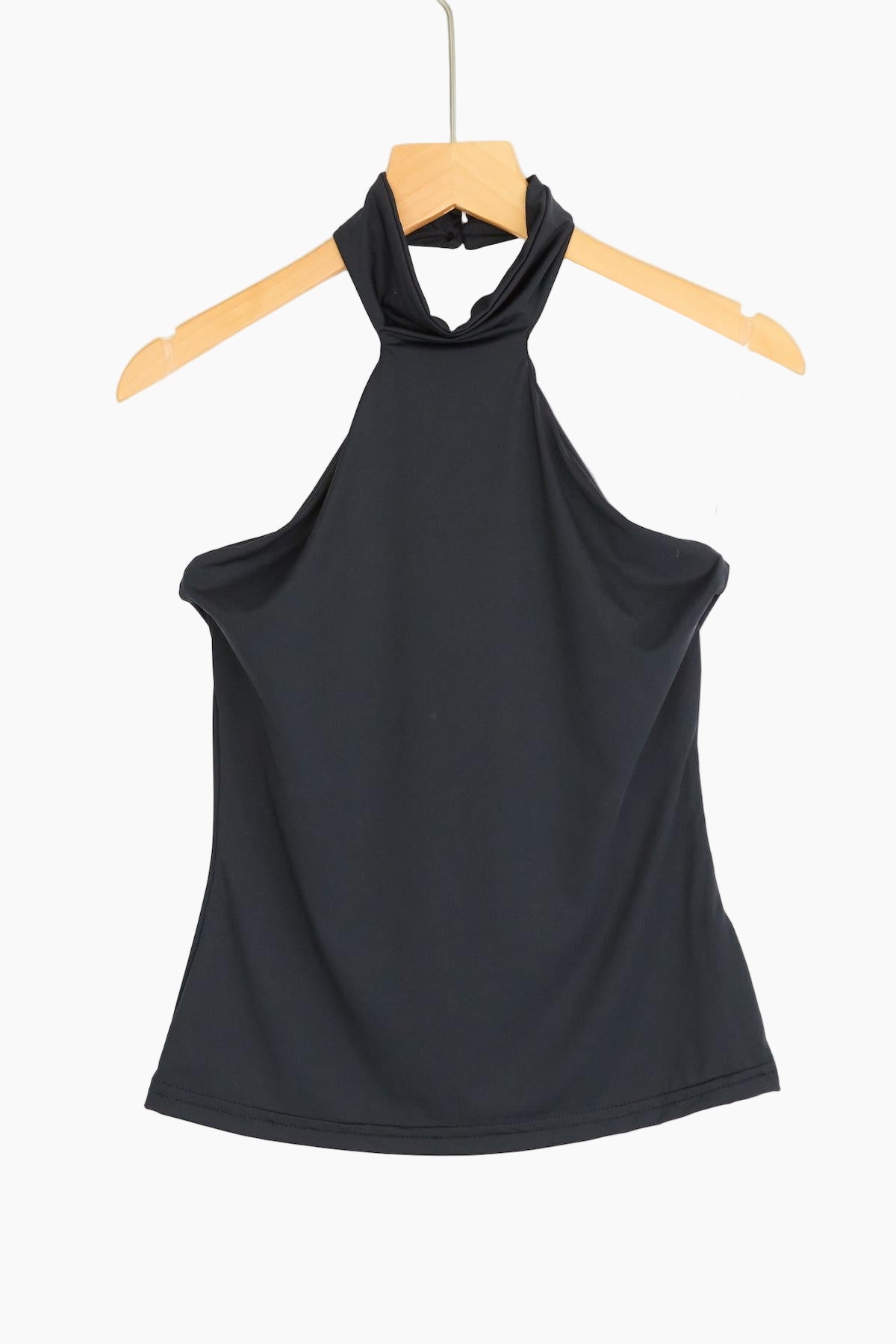 Black halter top on a wooden hanger 