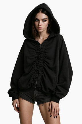 Person wearing a black hoodie and denim shorts 