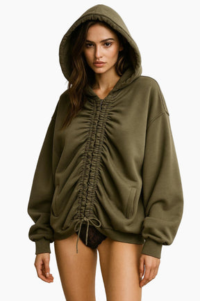 Woman wearing a green hoodie with ruched details 