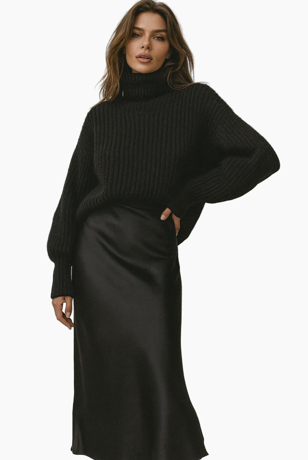 Woman wearing a black ribbed sweater and black satin skirt 