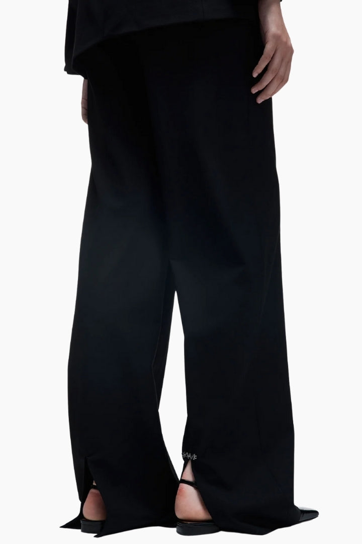 Black pants with cut-out details on a white background