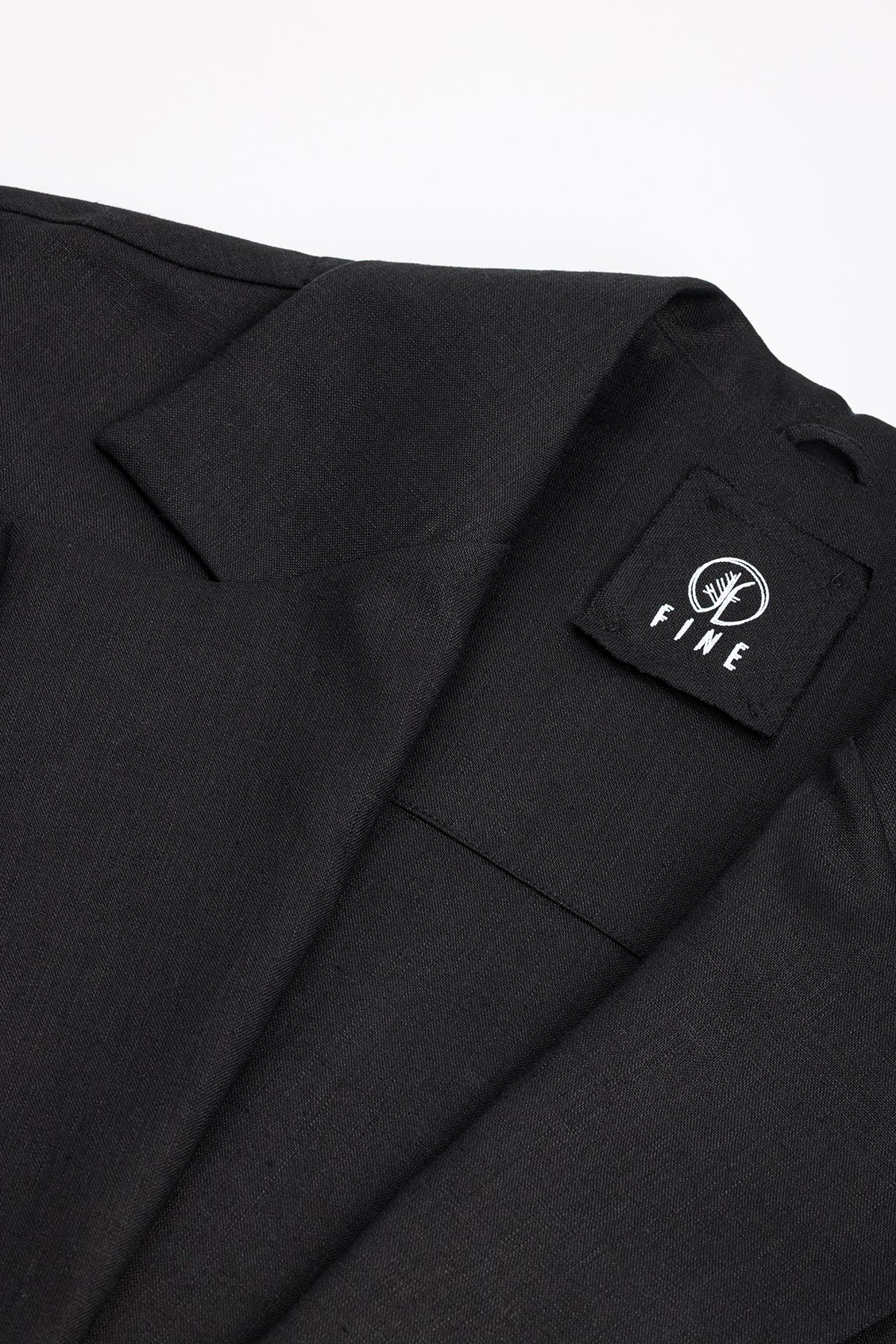 Black suit jacket with a visible brand logo on a white background