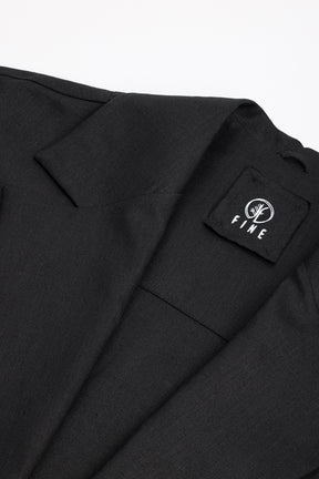 Black suit jacket with a visible brand logo on a white background