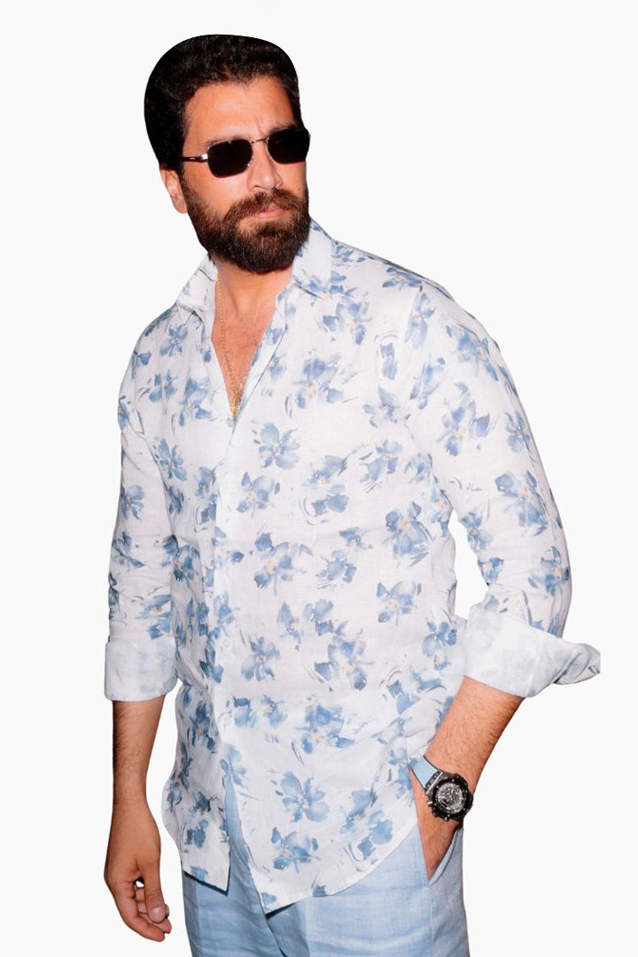 Man wearing a white floral shirt with rolled-up sleeves 