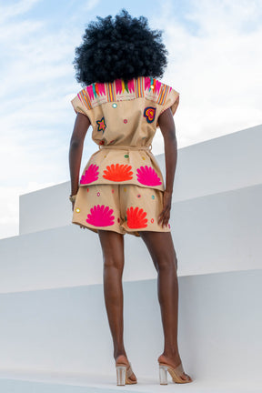 Person wearing a colorful outfit with shell patterns on a white background